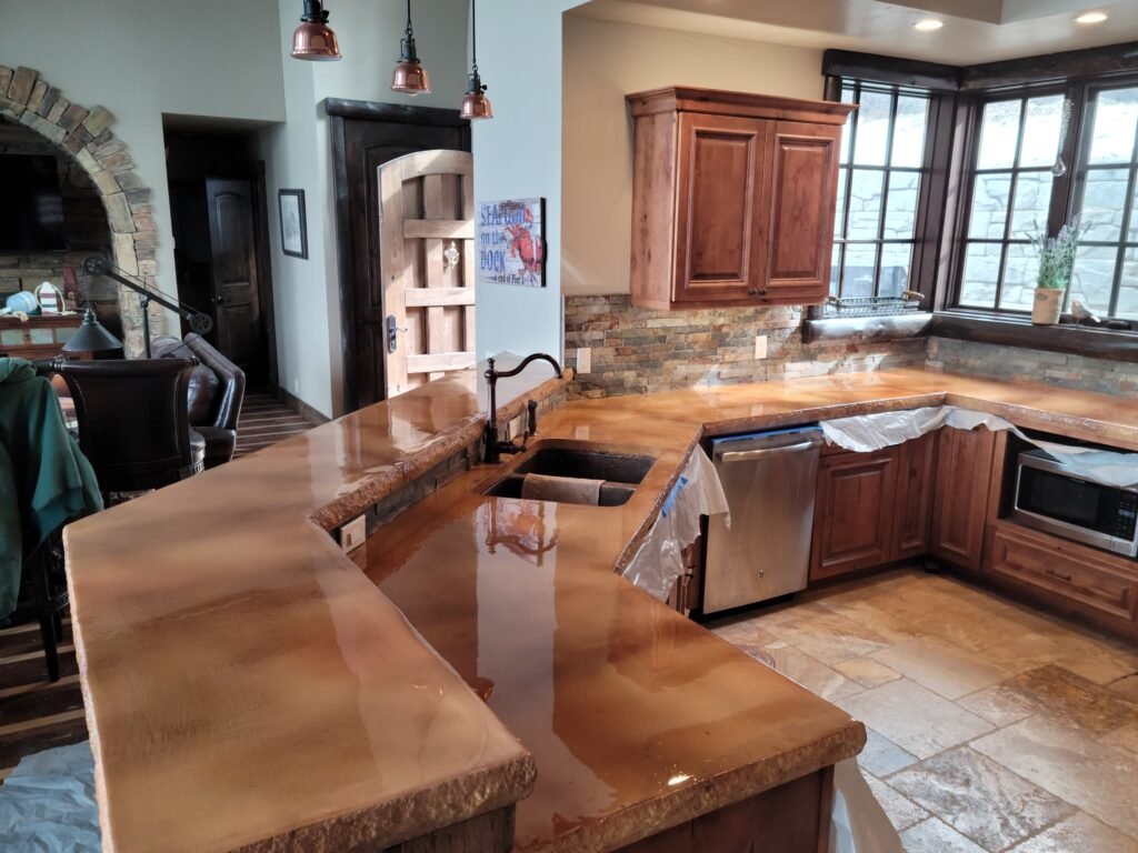 A kitchen with concrete countertops that has Rockfaced edges and epoxy to give a more rustic look that the owner wanted.