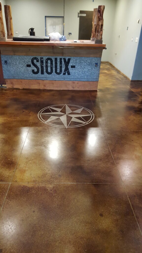 This particular client of Concepts on Concrete's wanted their logo painted into the design of their commercial epoxy floors.