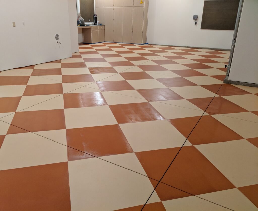 custom epoxy floors designed to look like tile, showcasing the wide range of customization epoxy floors allow for.